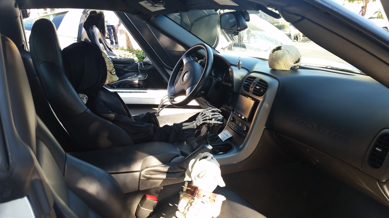 Inside the Vette monstrosity. Skeleton driver. Skull on dash. Skeleton dog in passenger’s seat.